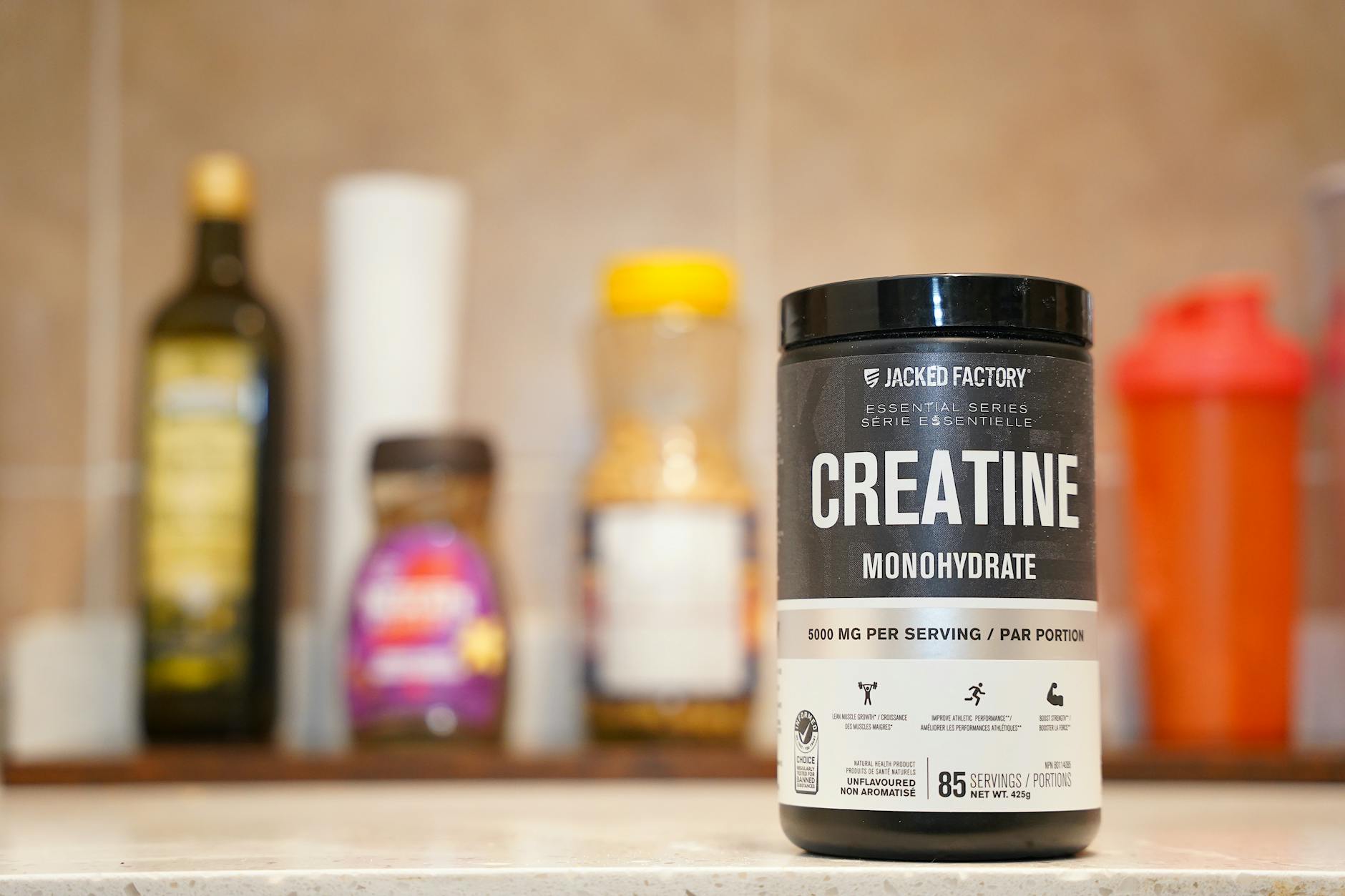 Creatine monohydrate supplement powder on a kitchen counter