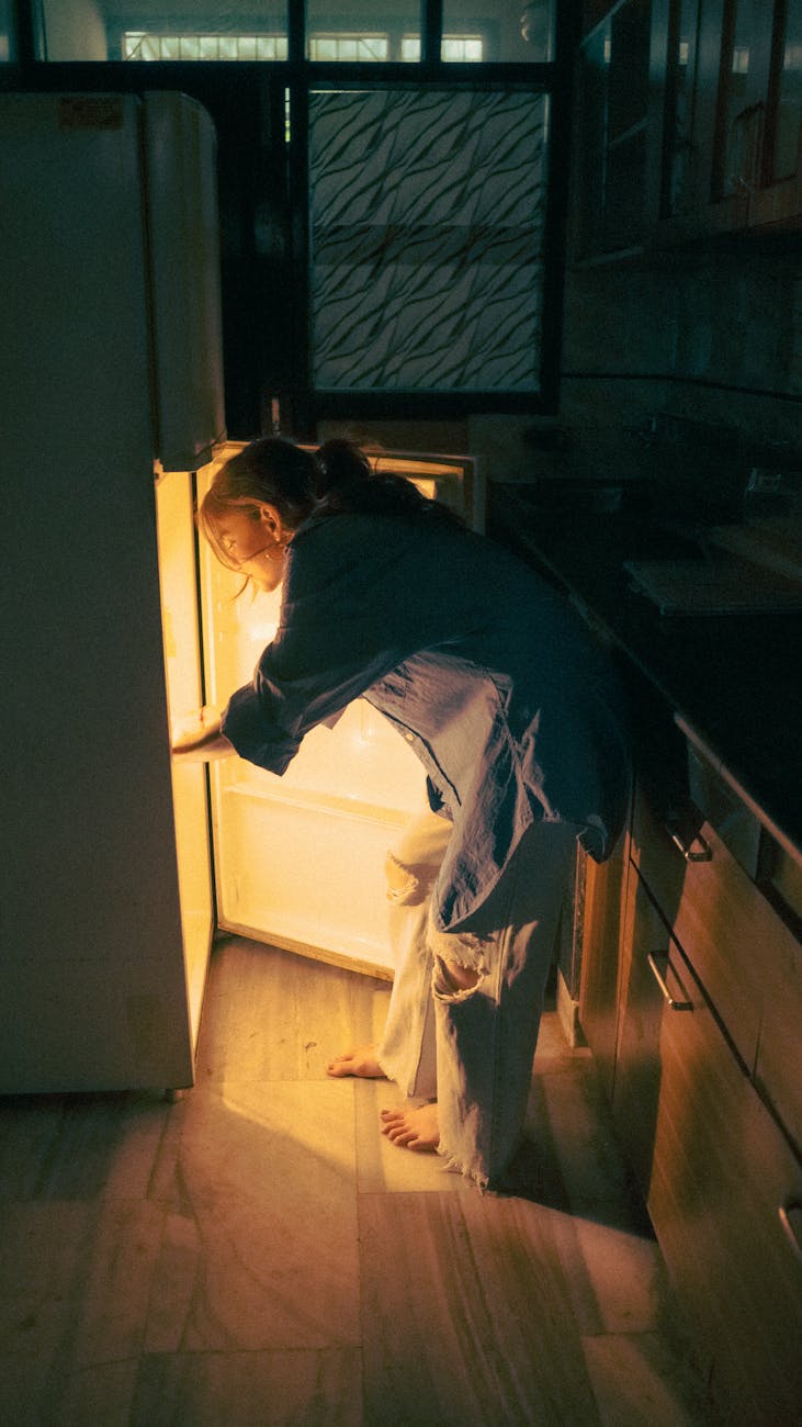 Woman eating a snack in bed late at night