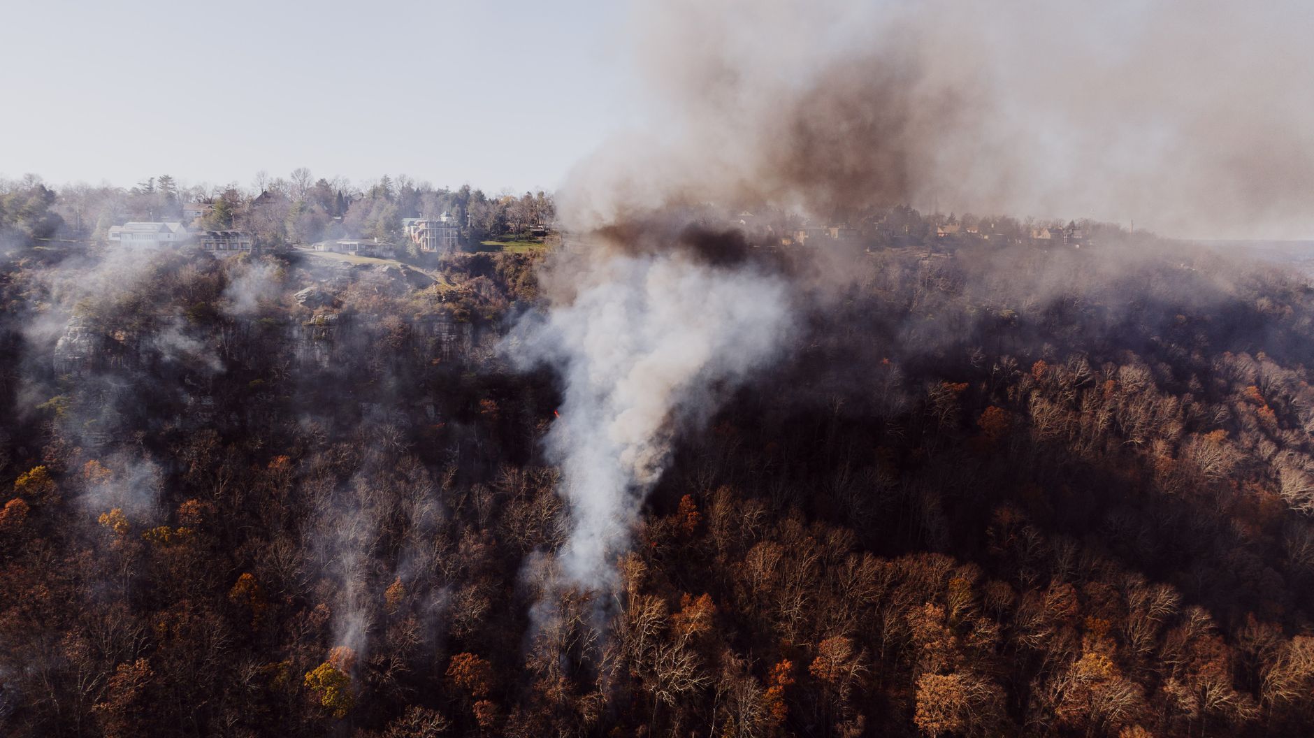 Aerial view of smoke rising from an active forest fire