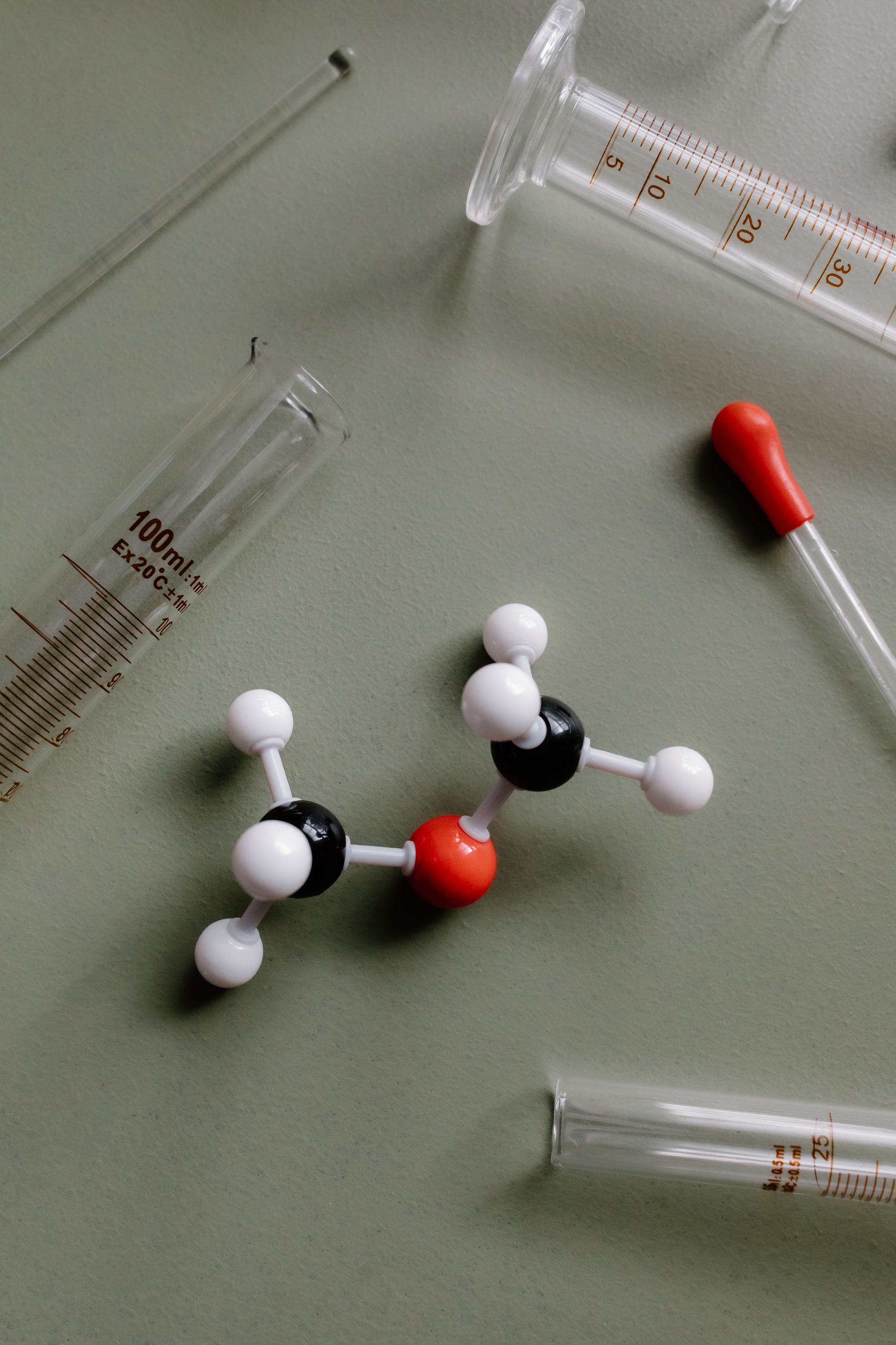Laboratory glassware and a pipette, representing peptide testing and evidence review.